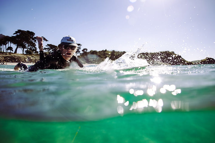 Man surfing in NZ wearing Vilo sunglasses